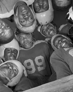 Higher Education Prints: Africans American football huddle at Bethune-Cookman College