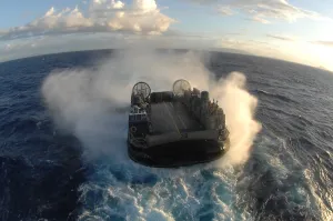 Water Transport Prints: Air cushion technology landing craft moving over the water approaches its mother ship in the Pacific Ocean July 12 2008