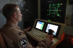 Remote Control Prints: An Air Force officer maneuvers an unmanned Predator reconnaissance airplane over Iraq by remote control at Balad Air