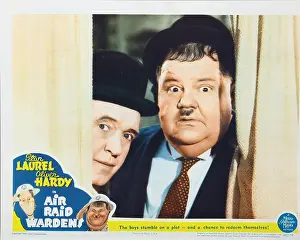 September Prints: AIR RAID WARDENS, US lobbycard, from left: Stan Laurel, Oliver Hardy, 1943