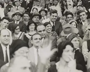 Mobster Prints: Al Capone (center), seated in front of three women, watching a college football game