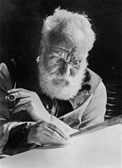 Bell Prints: Alexander Graham Bell (1847-1922), writing at his desk in his study in Washington. 1913