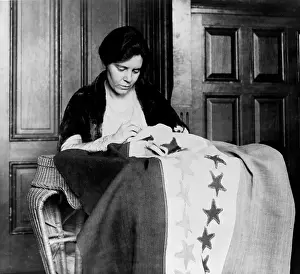 Suffrage Prints: Alice Paul (1885-1977) sewing another star onto the 'Suffrage Flag