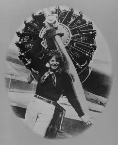 Amelia Prints: Amelia Earhart (1897-1937), posting in front of the propeller of her Lockheed L-10E Electra on July 8