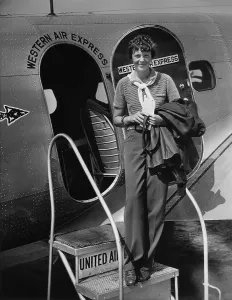 July Prints: Amelia Earhart 1897-1937 standing in the door of a Western Airlines planes in California as she embarks to New York to