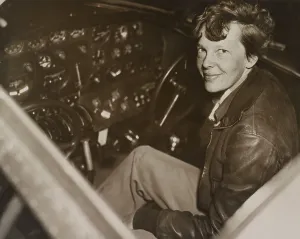 Flyers Prints: Amelia Earhart sitting in the cockpit of her Lockheed Electra airplane