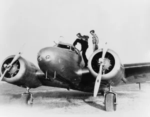 Amelia Prints: Amelia Earhart stanind on the wing of her Lockheed L-10E Electra airplane