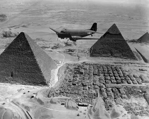 Lcgr1310 Prints: American Air Transport Command plane flies over the pyramids of Egypt