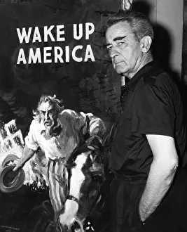 Artist Prints: American artist and cartoonist James Montgomery Flagg stands next to his poster for the Wake Up America Committee