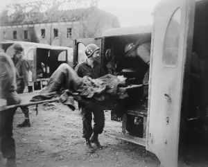 Ambulance Prints: American medics place an almost-dead German slave laborer in an ambulance at Nordhausen