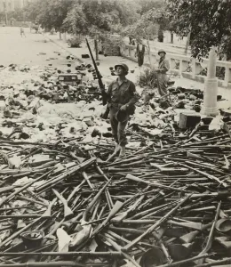 Sicily Prints: American M.P. standing on a large pile of Italian weapons on a street in Palermo