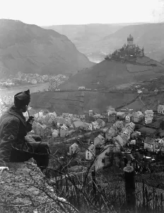 Relaxing Prints: American soldier looks toward an old castle perched on a hilltop above the Moselle River and the town of Cochem