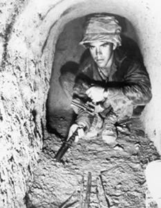Images Dated 8th May 2008: American soldier using a knife to probe the floor of a Viet Cong tunnel in the Iron Triangle north of Saigon