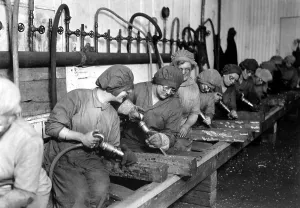Protective Clothing Prints: American women workers, hand chipping with pneumatic hammers
