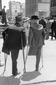 Handicapped Prints: Two amputees on crutches outside church on Sunday morning, St. Louis, Missouri. May1940