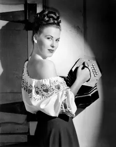 Peasant Blouse Prints: Andrea King, modeling a Lanz of California crepe blouse with hand-painted pattern, 1947
