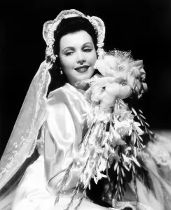 Wedding Dress Prints: Ann Miller, modeling a wedding ensemble, 1941, ph: A.L. Whitey Schafer