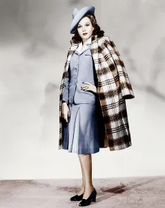 Incolr Prints: Ann Miller wearing light blue skirt suit and plaid overcoat, 1941