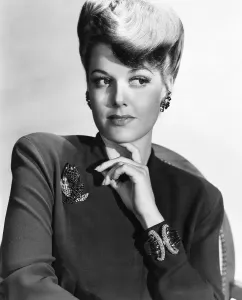 Jewelry Prints: Ann Sheridan wearing a clip of diamonds and sapphires in gold and a heavy diamond and gold bracelet