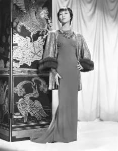 Asian American Prints: Anna May Wong in an Edith Head-designed crepe dinner gown with a jacket of emerald