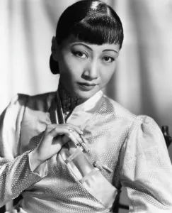 Bangs Prints: Anna May Wong, in an orange Nanking brocade robe with sandalwood fastenings, 1937