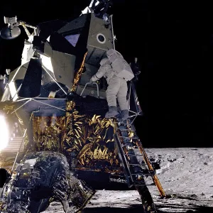 Alan Prints: Apollo 12 Astronaut Alan Bean starts down the ladder of the Lunar Module Intrepid to join Commander Charles Conrad