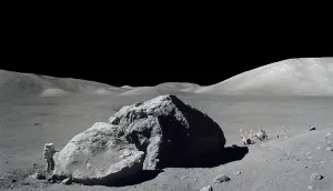 Spacesuits Prints: Apollo 17 Geologist-Astronaut Harrison Schmitt standing next to a huge