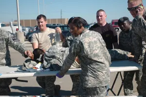 Mass Murder Prints: US Army first responders use a table as a stretcher for a soldier wounded by home-grown terrorist Major Nidal Malik