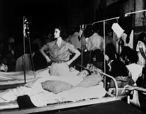 Intravenous Prints: Army nurse checks a soldier's glucose drip in the 36th Evacuation Hospital