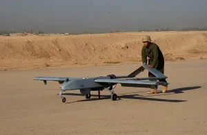 Electronics Prints: US Army soldier with an intelligence battalion recovers an Unmanned Aerial Vehicle following a mission over the Baqubah