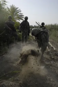 June Prints: US Army Soldiers search for buried weapons at a remote village outside of Lutafiyah located in the southern sector of