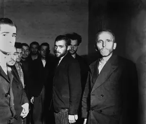 Imprisoned Prints: Arrested German Gestapo agents in a cell after the fall of Liege