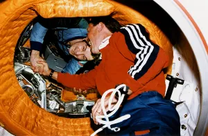 June Prints: Astronaut Robert Gibson, greets Cosmonaut Vladimir Dezhurov in space