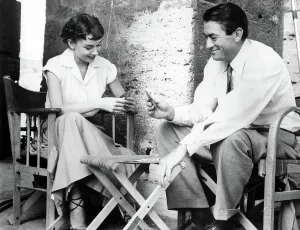 Directors Chair Prints: AUDREY HEPBURN and GREGORY PECK play cards while on location for ROMAN HOLIDAY, 1953