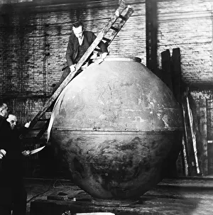 Explorer Prints: Auguste Piccard on a ladder examining the nacelle construction in his workshop
