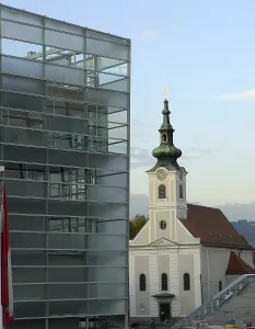 AUSTRIA. Linz. Ars Electronica Center and Urfahr parrish church.. AISA/Everett Collection - Image has fine art copyright