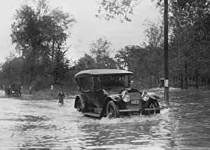 Automobiles Prints: Automobile driving through flood water in Bladensburg
