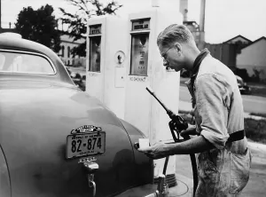 Gasoline Prints: An automobile service station attendant measures out gasoline in accordance with the World War II gasoline rationing