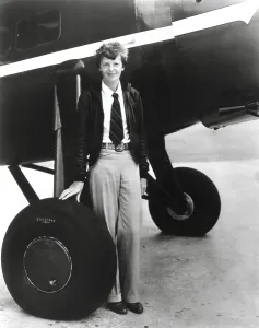 Flyers Prints: Aviator, Amelia Earhart, standing below her Bright Red Lockheed Vega airplane which she bought in 1929