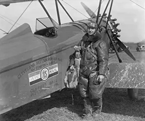 Flight Suit Prints: Aviator standing with plane labeled Cleveland Pittsburgh Air Mail and Express Route