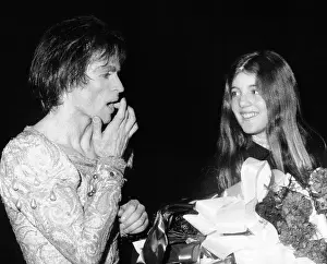 Caroline Prints: Ballet star Rudolph Nureyev treats a small cut on his finger caused by a thorn on the roses held by Caroline Kennedy
