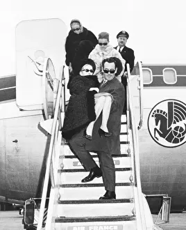 Colin Prints: Barbara Hutton is carried off an Air France by her companion