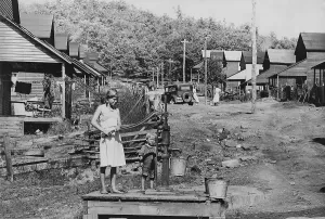 Utility Lines Prints: Barefoot children pump water in Wilder