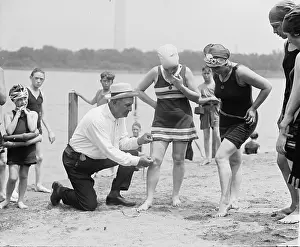 Flapper Prints: A beach official checks the amount of thigh exposed by a young ladies bathing suit in 1922