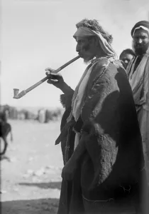 Images Dated 7th July 2008: Bedouin man smoking a long pipe. photograph 1920