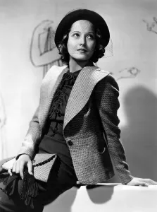 Wide Lapels Prints: BELOVED ENEMY, Merle Oberon wearing outfit designed by Omar Kiam, 1936