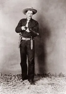 Revolvers Prints: Bill Bennett, Wild West detective, armed with a rifle, revolver and knife. Ca. 1900