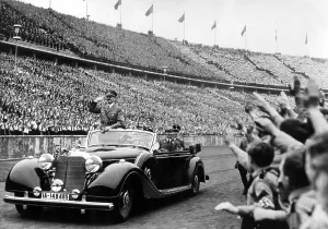 Olympics Prints: BERLIN--Adolph Hitler (in auto) salutes the huge