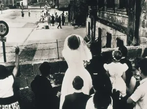Deutschland Prints: Berlin Wall. A newly-wed couple greets their families of the Soviet sector