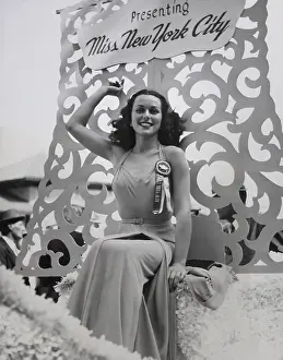 Winners Prints: Bess Myerson, seated on the Miss New York City float during the parade in Atlantic City